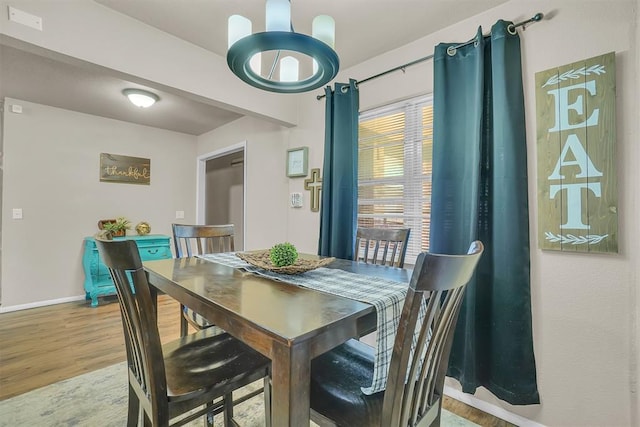 dining space with wood-type flooring