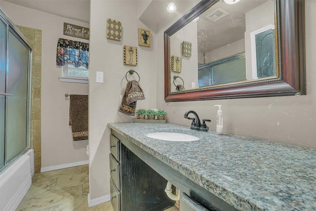 bathroom featuring vanity and combined bath / shower with glass door