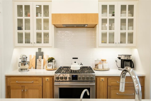 kitchen with tasteful backsplash and stainless steel gas stove