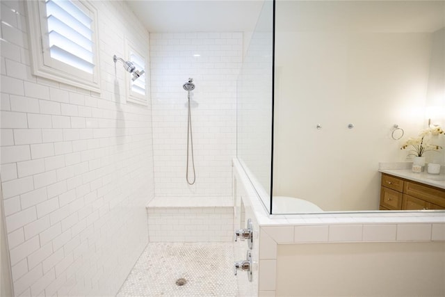 bathroom featuring vanity and tiled shower