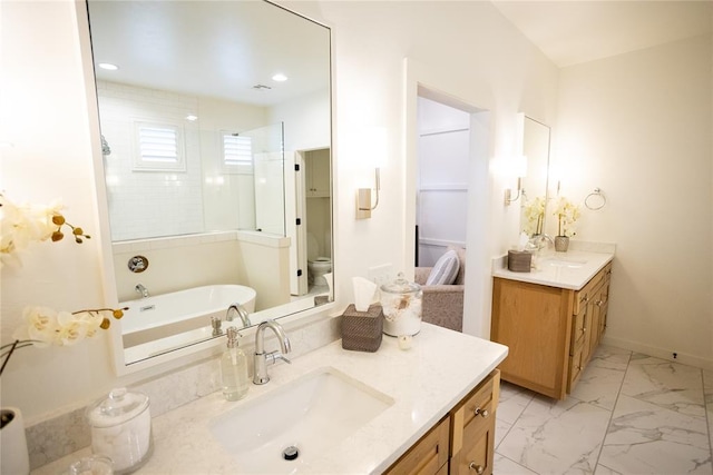 full bathroom with vanity, shower with separate bathtub, and toilet