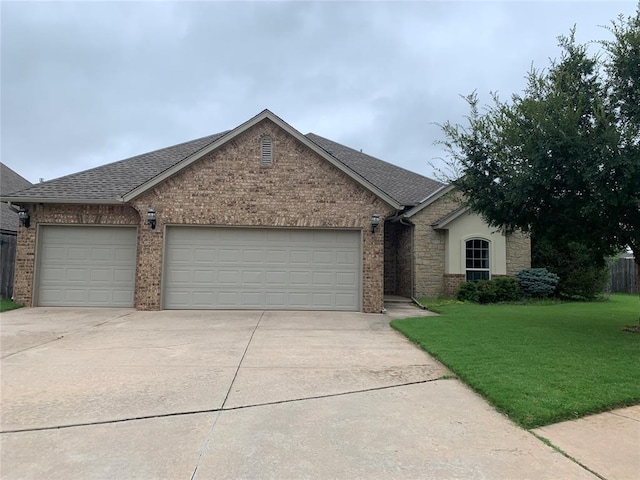 ranch-style home with a front yard and a garage