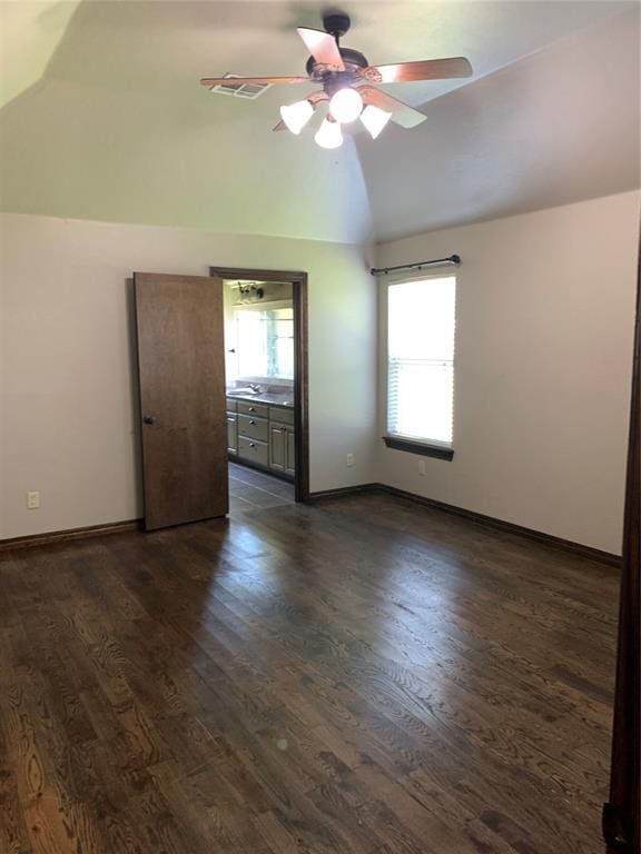 spare room with lofted ceiling, ceiling fan, and dark hardwood / wood-style flooring