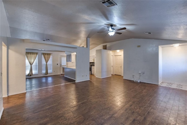 unfurnished living room with dark wood-type flooring, lofted ceiling, and a textured ceiling