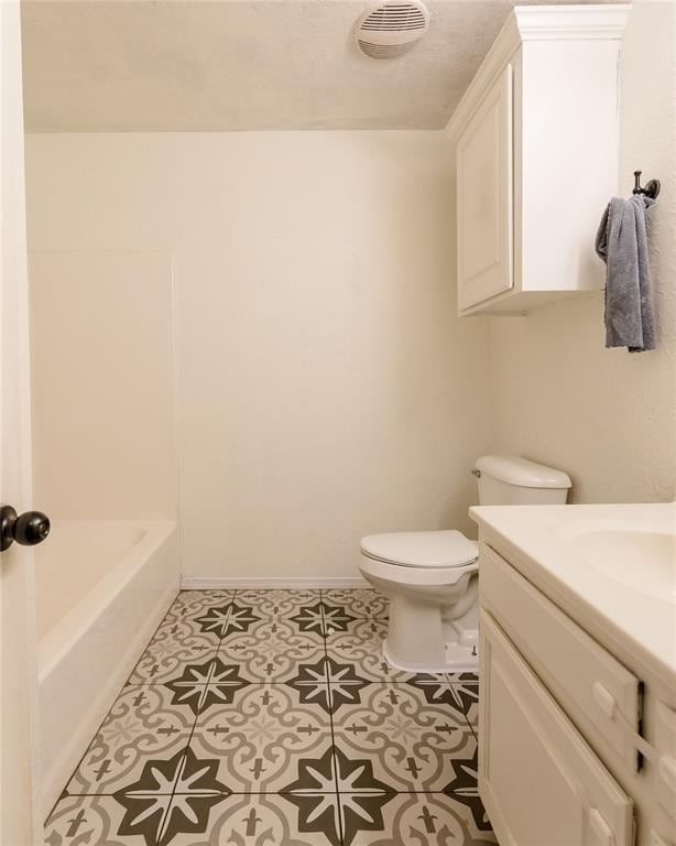 bathroom featuring tile patterned floors, vanity, and toilet