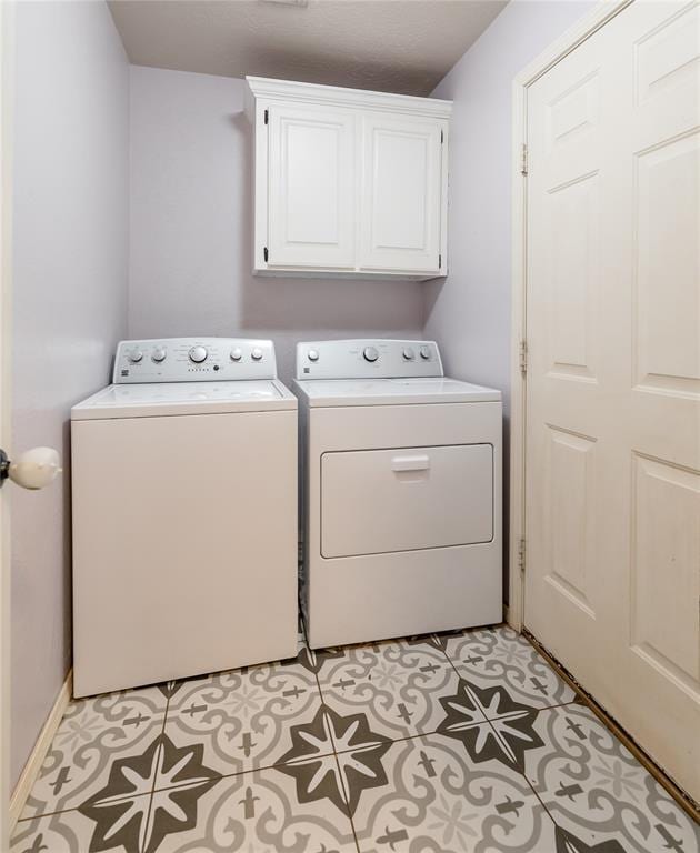 laundry room featuring cabinets and separate washer and dryer