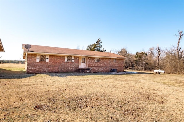 rear view of property featuring a yard