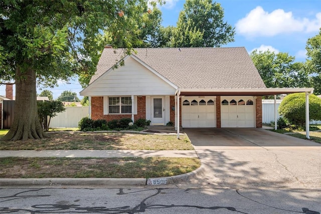 view of front of property featuring a garage and a carport