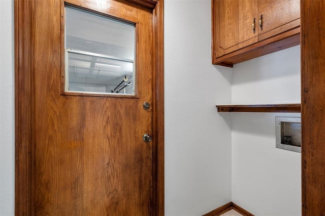 laundry area featuring washer hookup and cabinets