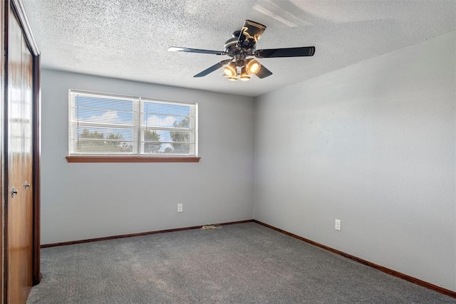 carpeted empty room with ceiling fan and a textured ceiling