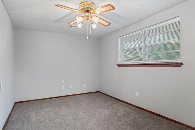 empty room with carpet floors, a textured ceiling, and ceiling fan