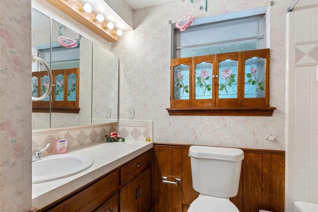 full bathroom featuring vanity, toilet, separate shower and tub, and decorative backsplash