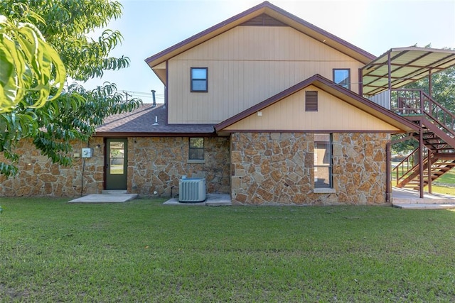 back of property featuring a yard and central AC unit