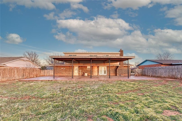 back of house featuring a yard and a patio