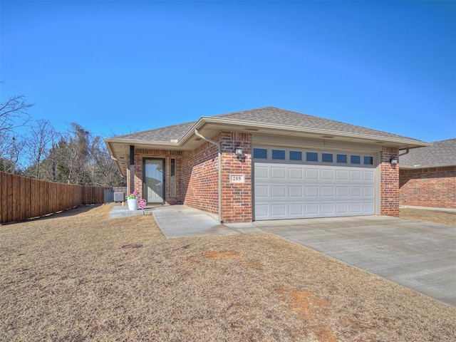 view of front of home with a garage and central air condition unit