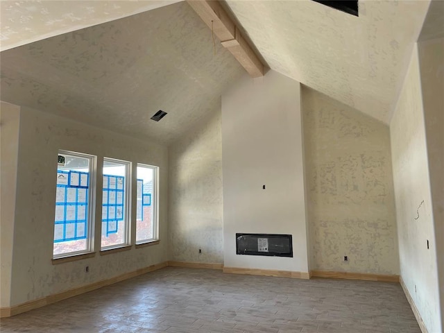 unfurnished living room with high vaulted ceiling, heating unit, and beam ceiling