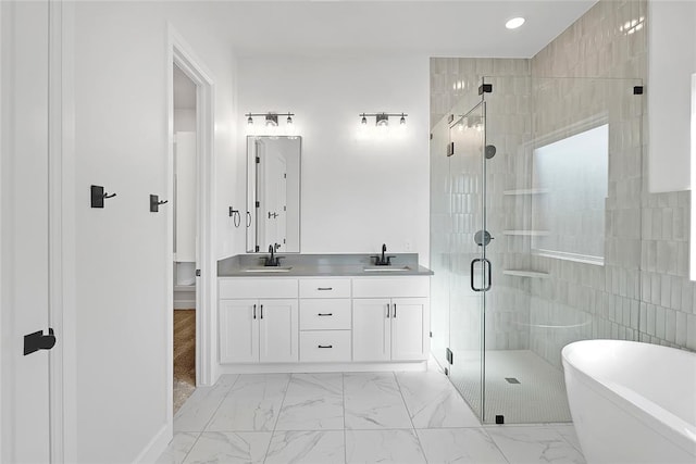 bathroom with independent shower and bath and vanity