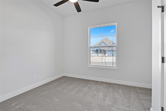 carpeted spare room with ceiling fan