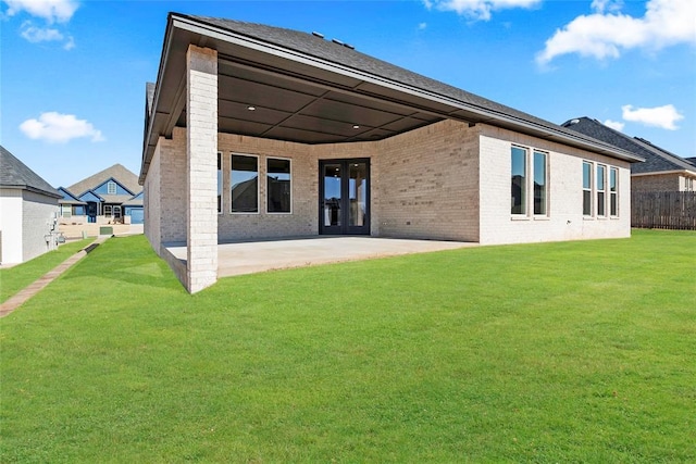 back of house featuring a yard and a patio