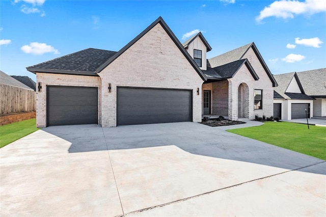 view of front of home with a garage and a front lawn