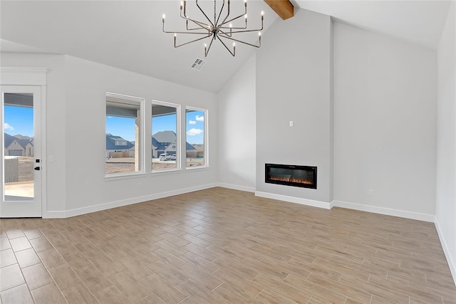 unfurnished living room featuring beamed ceiling, high vaulted ceiling, and a notable chandelier