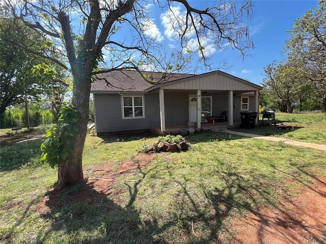 view of front of home with a porch and a front yard