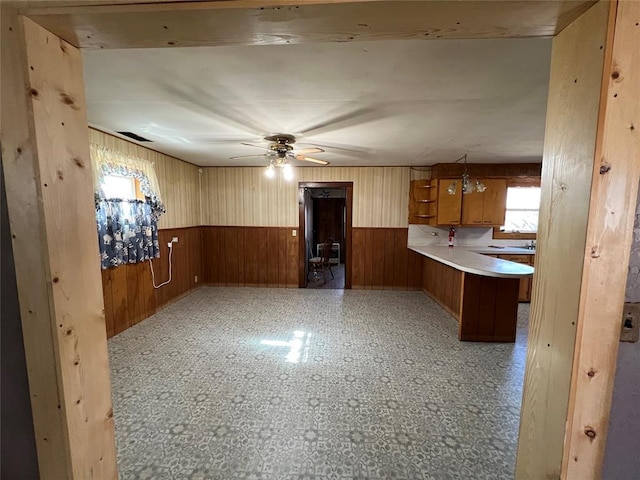 kitchen featuring ceiling fan and kitchen peninsula