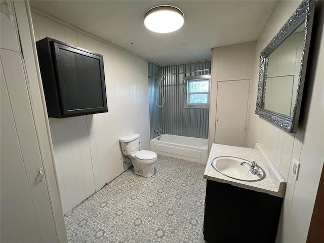 full bathroom featuring toilet, wooden walls, vanity, and  shower combination