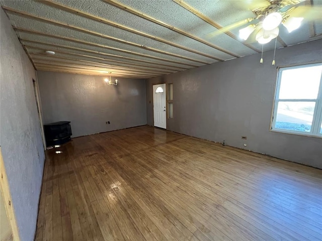 basement with ceiling fan and wood-type flooring