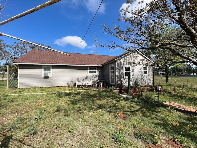 rear view of house with a yard