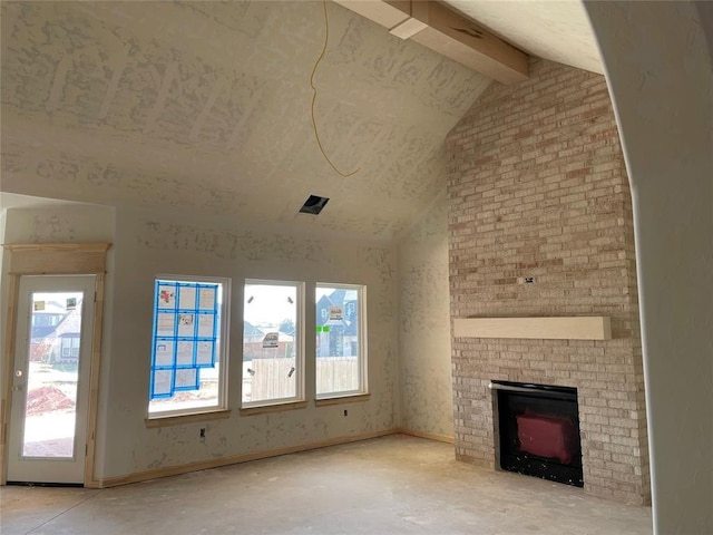 unfurnished living room with a brick fireplace and vaulted ceiling with beams