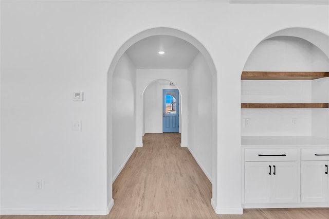 hallway with light hardwood / wood-style floors