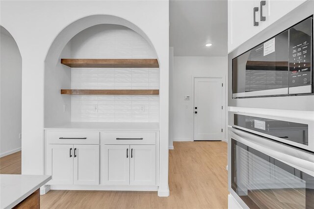 kitchen featuring white cabinetry, stainless steel appliances, and light hardwood / wood-style flooring