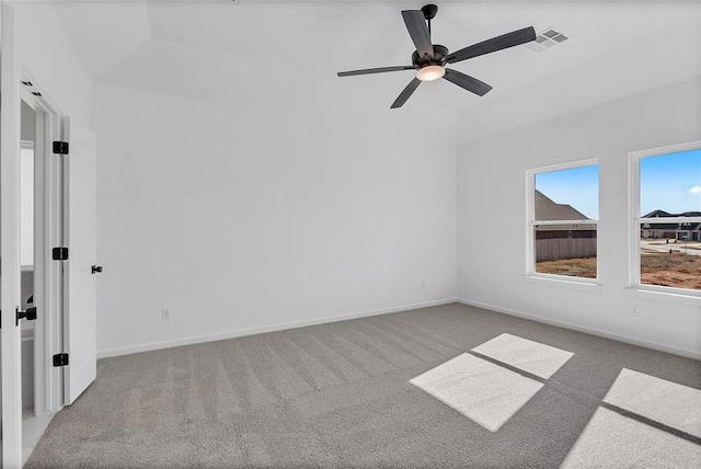 carpeted spare room featuring ceiling fan