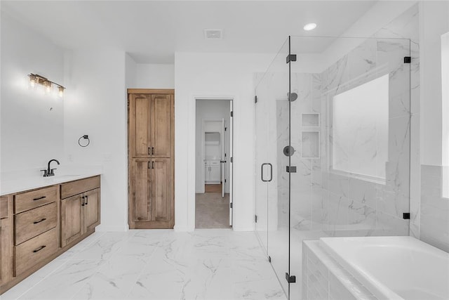 bathroom with vanity and separate shower and tub