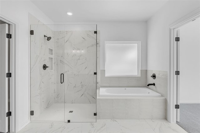 bathroom featuring separate shower and tub