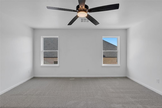 carpeted spare room with ceiling fan