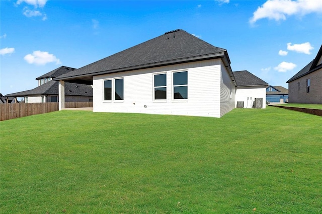 rear view of house with a lawn