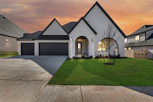 view of front of property with a garage and a yard