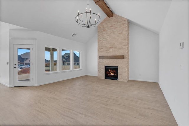 unfurnished living room with beam ceiling, a chandelier, high vaulted ceiling, a fireplace, and light hardwood / wood-style floors