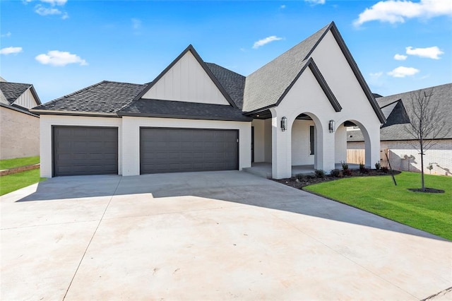 french country inspired facade featuring a garage and a front lawn