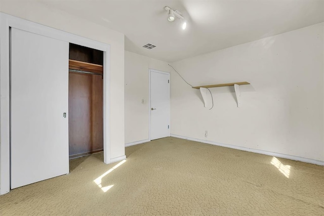 unfurnished bedroom featuring carpet flooring, a closet, and vaulted ceiling