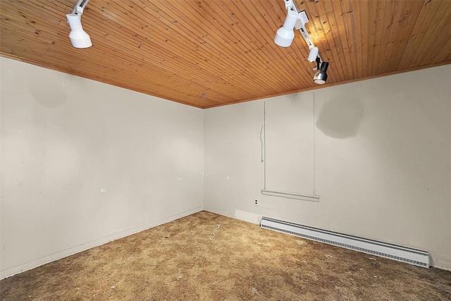 spare room with carpet floors, a baseboard heating unit, and wood ceiling