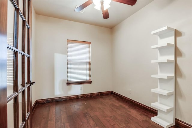 unfurnished room with ceiling fan and dark wood-type flooring