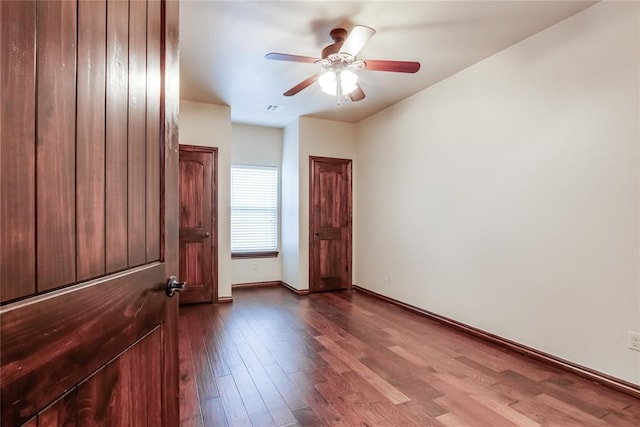 empty room with ceiling fan and wood-type flooring