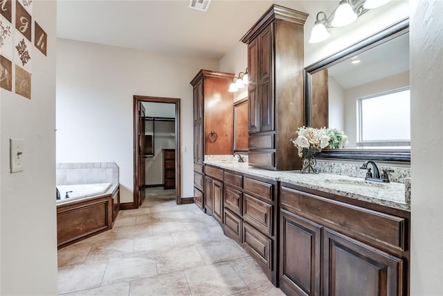 bathroom featuring a tub to relax in and vanity