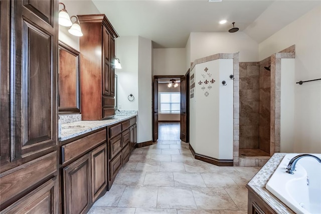 bathroom featuring lofted ceiling, vanity, and independent shower and bath