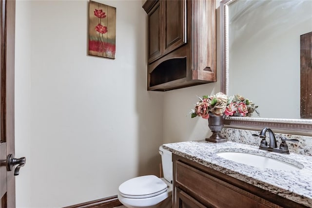 bathroom with toilet and vanity