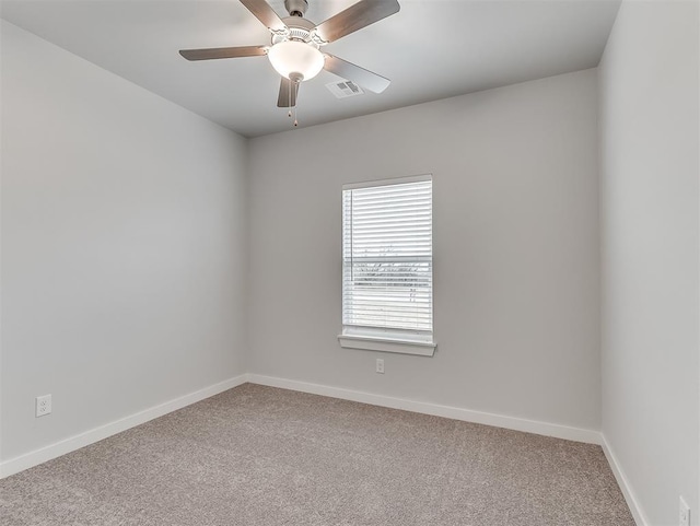 unfurnished room featuring ceiling fan, carpet floors, visible vents, and baseboards