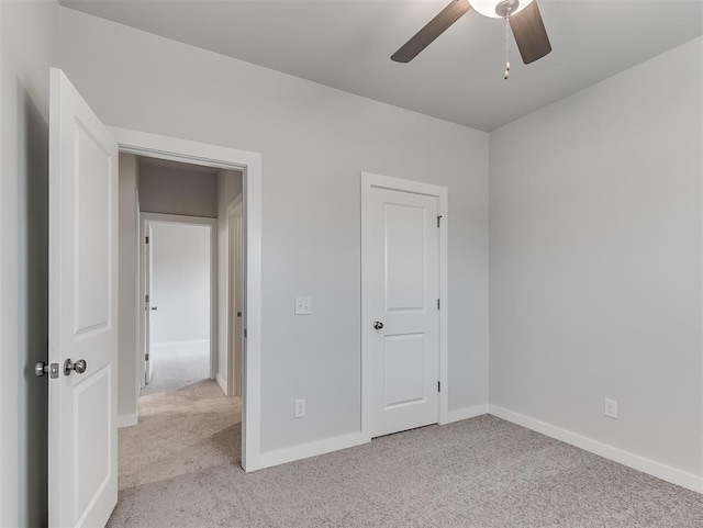 unfurnished bedroom featuring a ceiling fan, baseboards, and carpet flooring